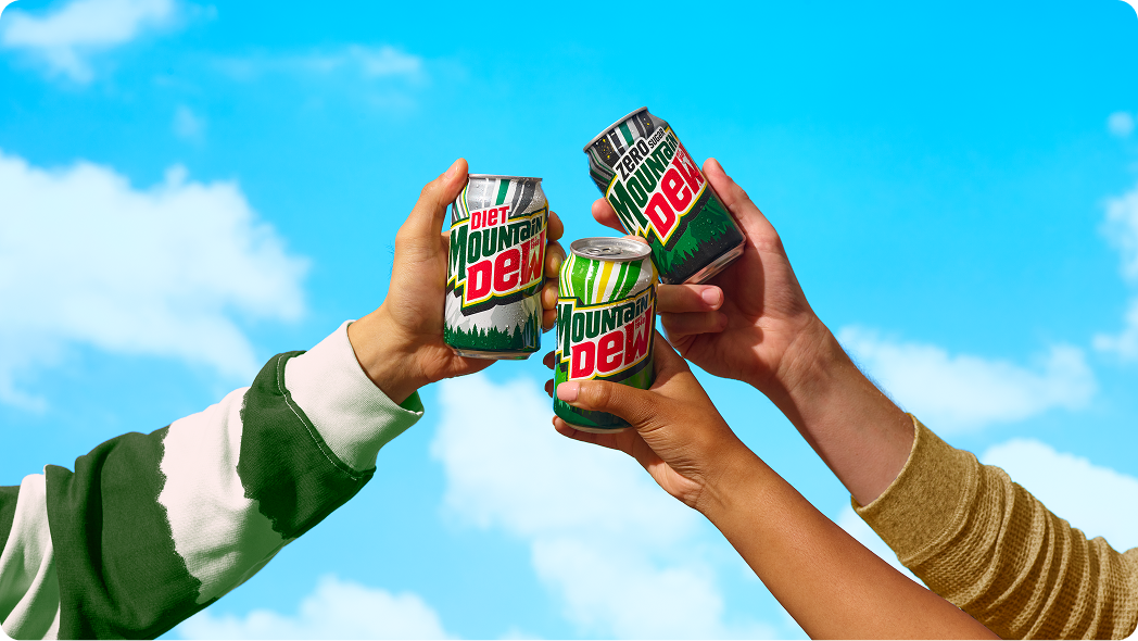 Hands holding dew cans