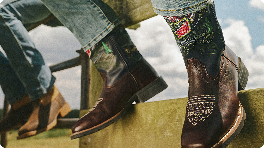 Boots resting on fence